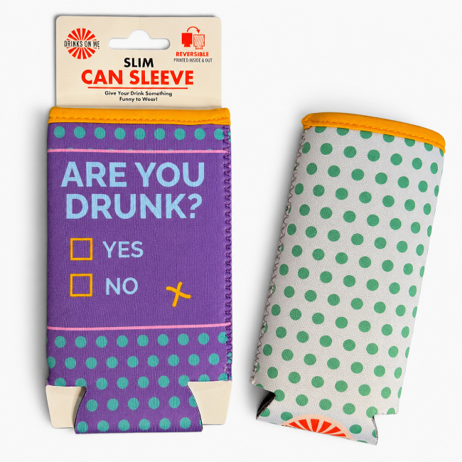 A slim can sleeve beverage holder shown in two views: one front-facing with a purple body, teal polka dots, and the text 'ARE YOU DRUNK?' with checkboxes, and one side view showing a white body with teal polka dots and an orange top rim.