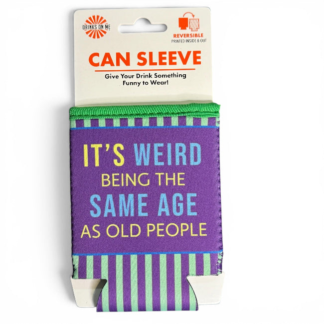 A novelty can sleeve in retail packaging, featuring a purple front panel with the text 'IT'S WEIRD BEING THE SAME AGE AS OLD PEOPLE' in yellow and blue lettering, with green and purple striped top and bottom bands.
