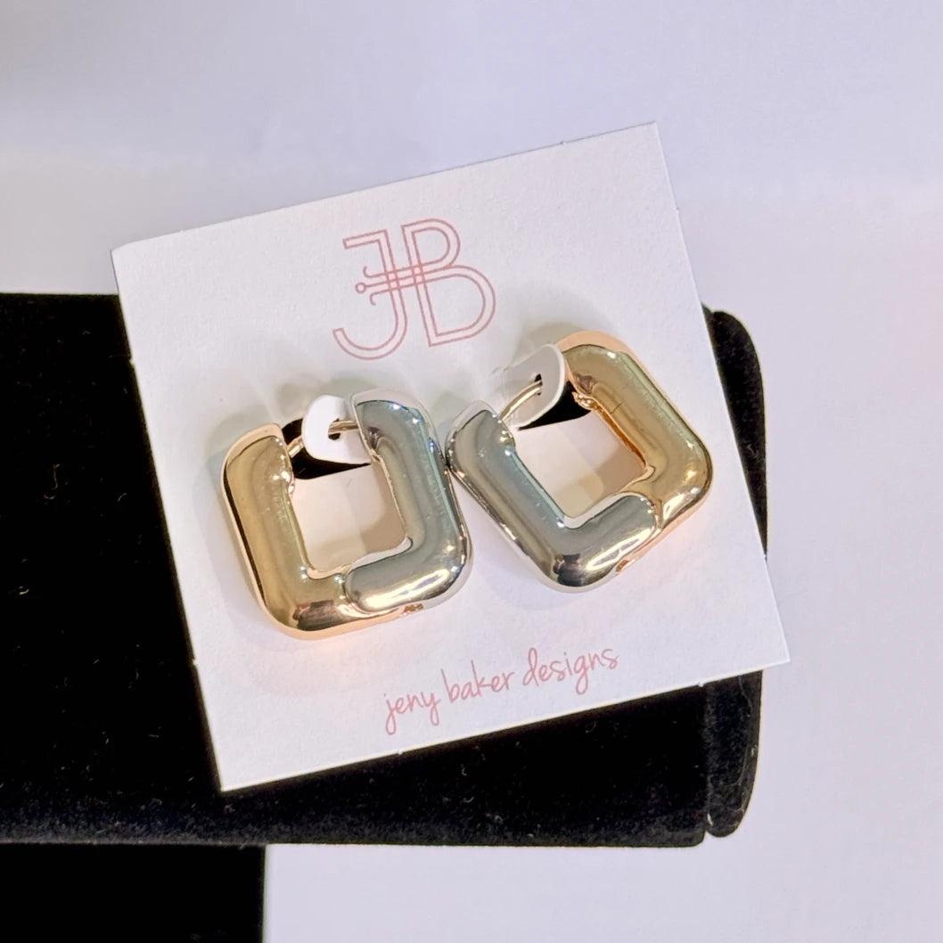 Gold and silver earrings on a 'JB' branded card