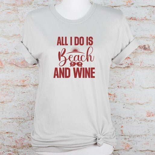 White t-shirt with red text 'All I do is Beach and Wine' on a mannequin against a textured white background.