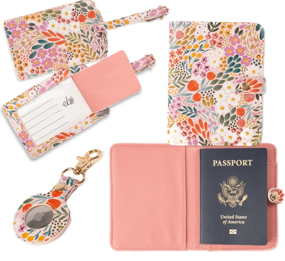 Set of travel accessories with floral patterns including a passport holder, luggage tag, and card holder.